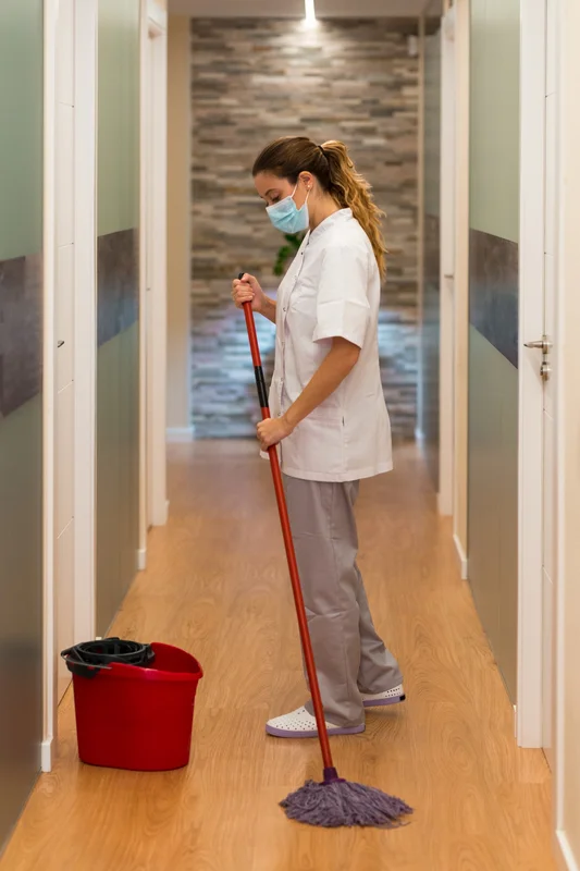 Commercial cleaner disinfecting hallway in Chicago office building